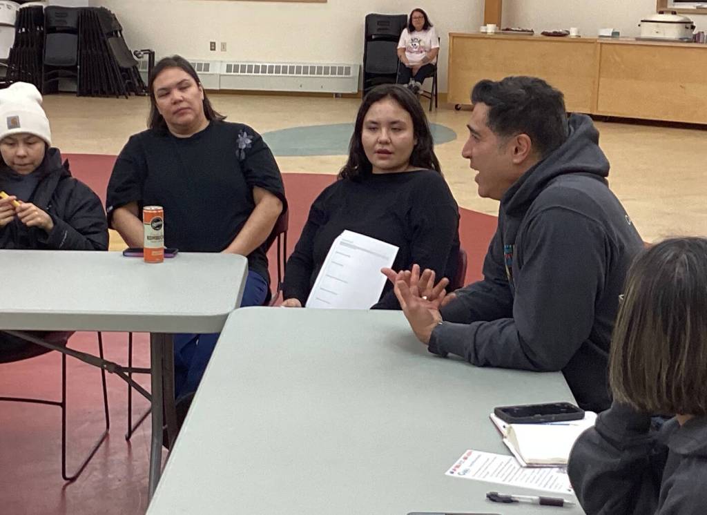 Cuso Canadian program advisor Ed Diazgranados, in the grey hoodie, explains Cuso International&rsquo;s micro-grants funding to Ndilo youths on Jan. 7. Photo courtesy of Nancy Vail
