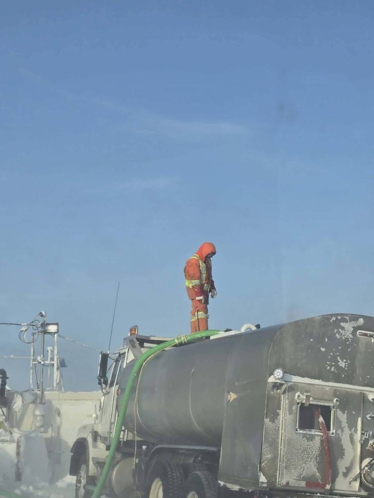 A water truck operator fills up a vehicle at the Gjoa Haven pump station. Contributed photo